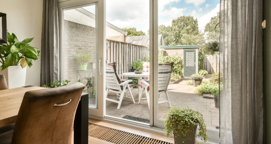 Sliding glass door at home leading to a paver patio